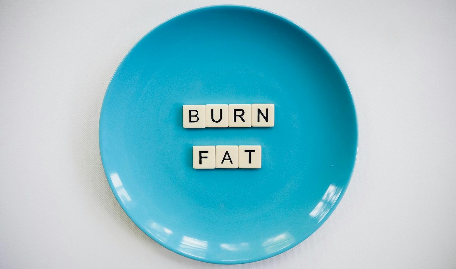 https://www.pexels.com/photo/photo-of-a-burn-fat-text-on-round-blue-plate-2383009/